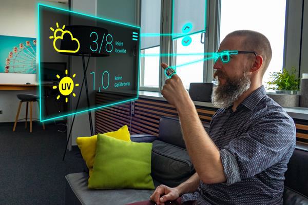 Mann mit UbiAct-Ring und Brille sieht vor sich virtuelle Wetterdaten 